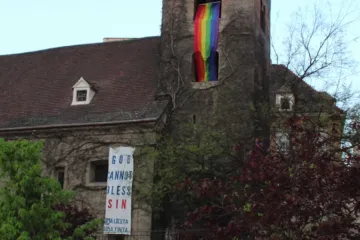 The banner hung by the group Christus Vincit from St. Rupert’s Church in Vienna, Austria.